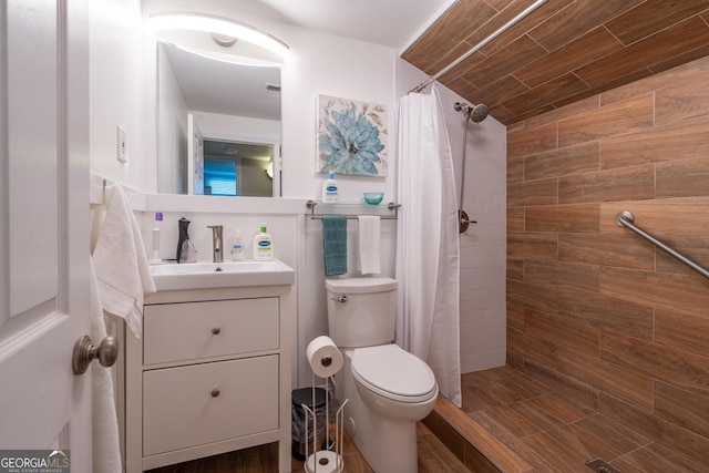 bathroom featuring vanity, toilet, and a shower with curtain