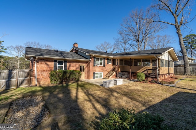 rear view of house with a yard and a patio