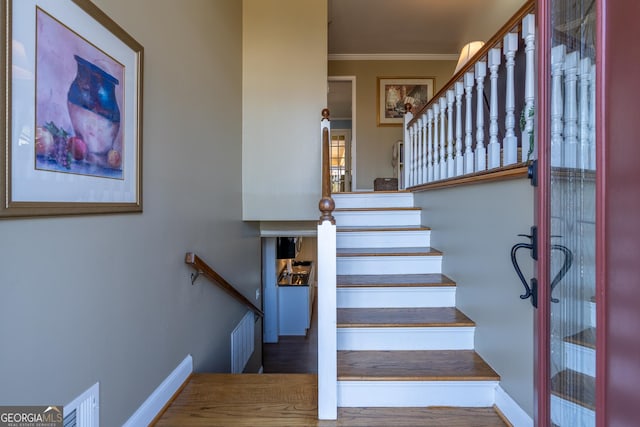 staircase with ornamental molding