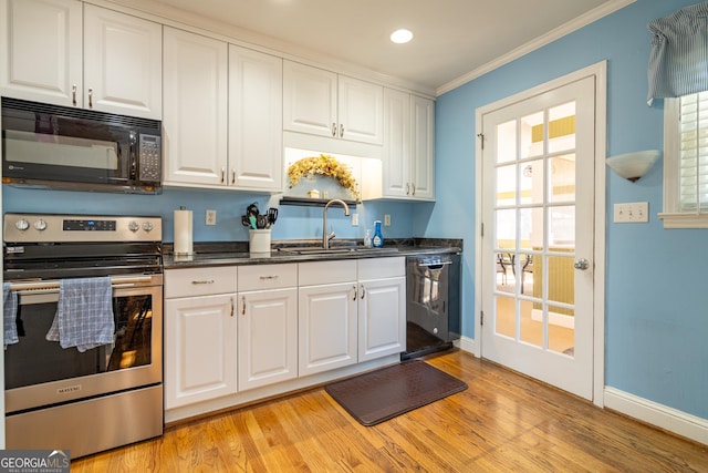 kitchen with crown molding, sink, light wood-type flooring, white cabinetry, and black appliances