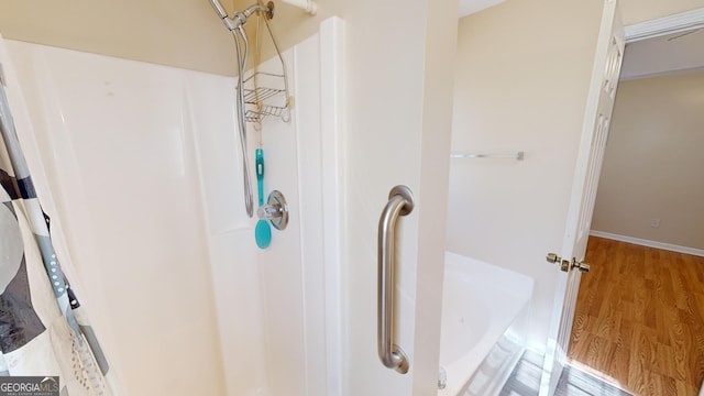 bathroom featuring hardwood / wood-style flooring and separate shower and tub