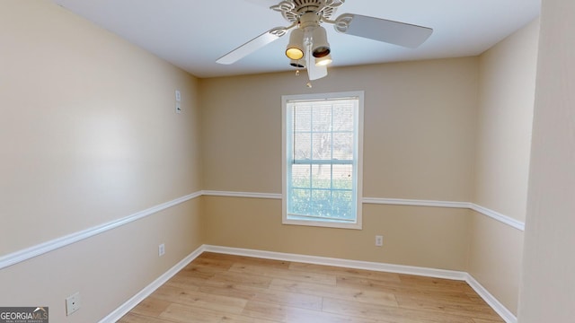 spare room featuring light wood-type flooring and ceiling fan