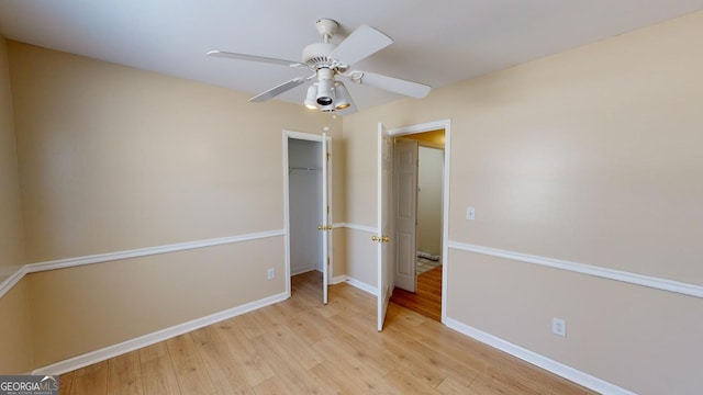 unfurnished bedroom with light wood-type flooring, a closet, and ceiling fan