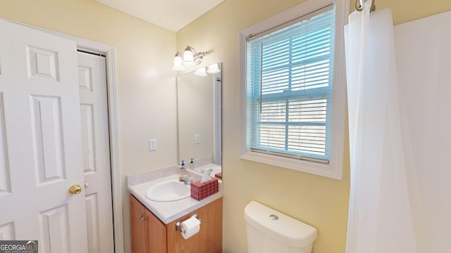 bathroom featuring toilet and vanity