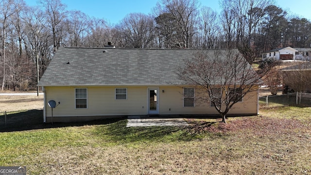 back of house featuring a patio and a lawn