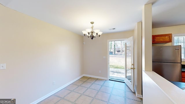 entryway with a notable chandelier and a healthy amount of sunlight