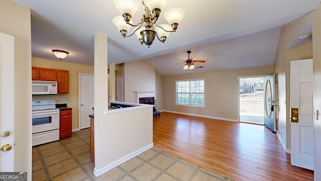 kitchen with hardwood / wood-style flooring, ceiling fan with notable chandelier, and white appliances