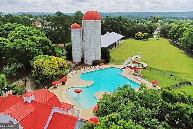 view of swimming pool with a patio area and a yard