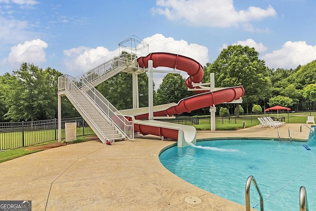 view of swimming pool with a water slide