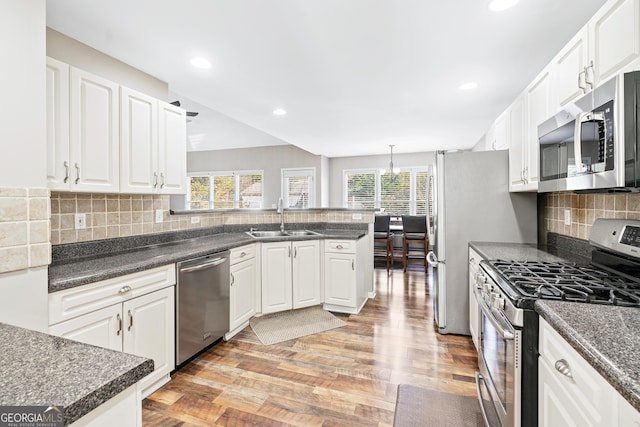 kitchen featuring white cabinetry, sink, backsplash, and stainless steel appliances