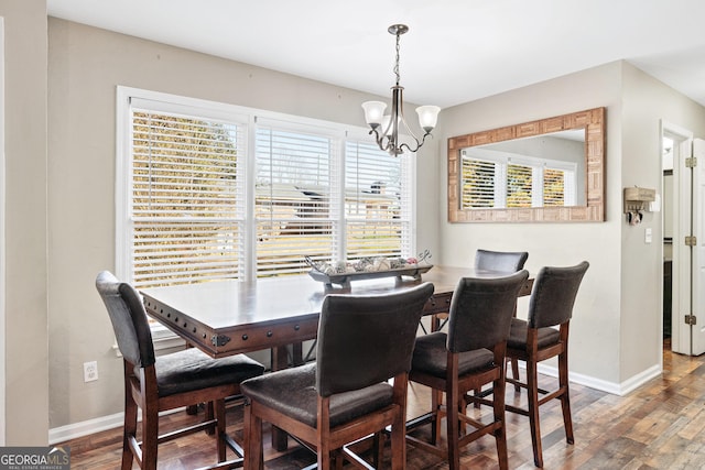 dining area with an inviting chandelier and wood-type flooring