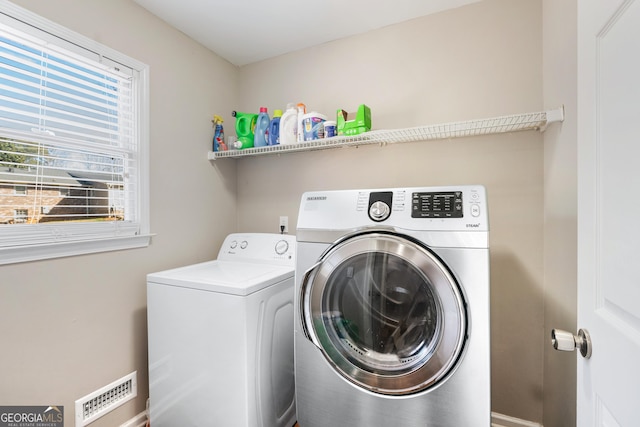 laundry area with washing machine and clothes dryer