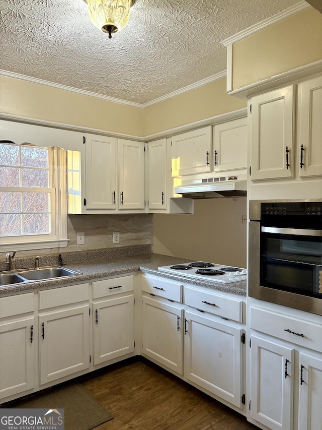 kitchen with sink, white cabinetry, white electric cooktop, and oven