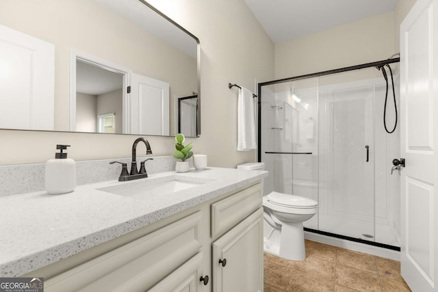 bathroom with an enclosed shower, vanity, and toilet