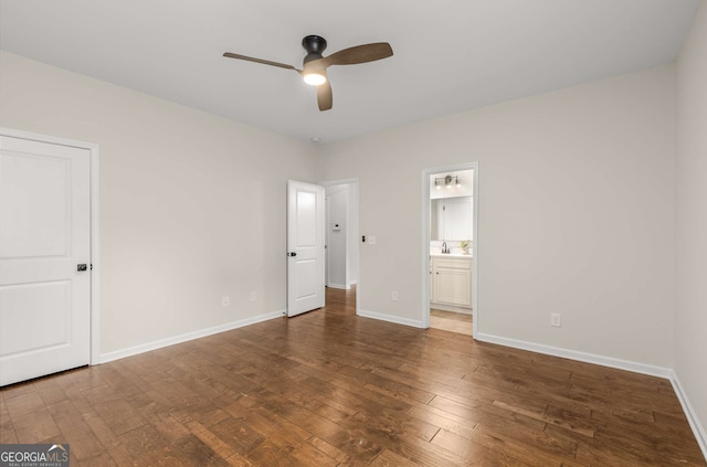 unfurnished bedroom with ceiling fan, dark hardwood / wood-style floors, and ensuite bath