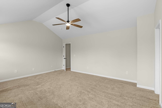 carpeted empty room with vaulted ceiling and ceiling fan