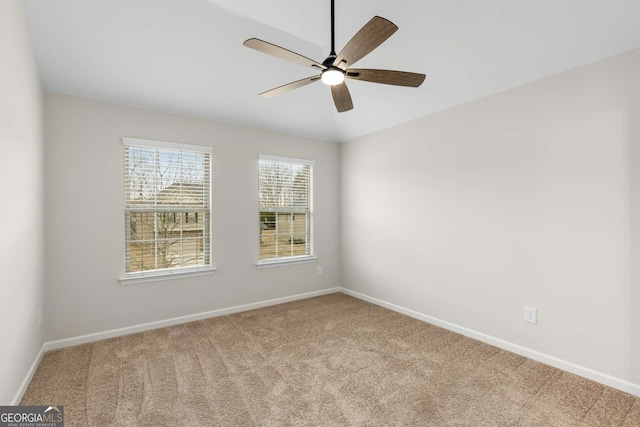 unfurnished room featuring light colored carpet and ceiling fan