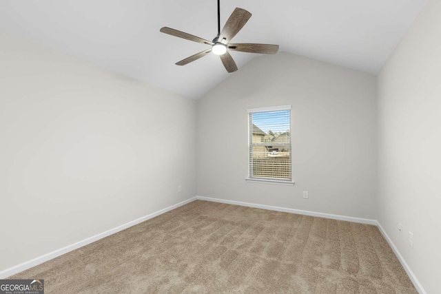 empty room with lofted ceiling, light carpet, and ceiling fan