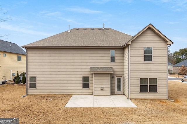 rear view of house with a yard and a patio area