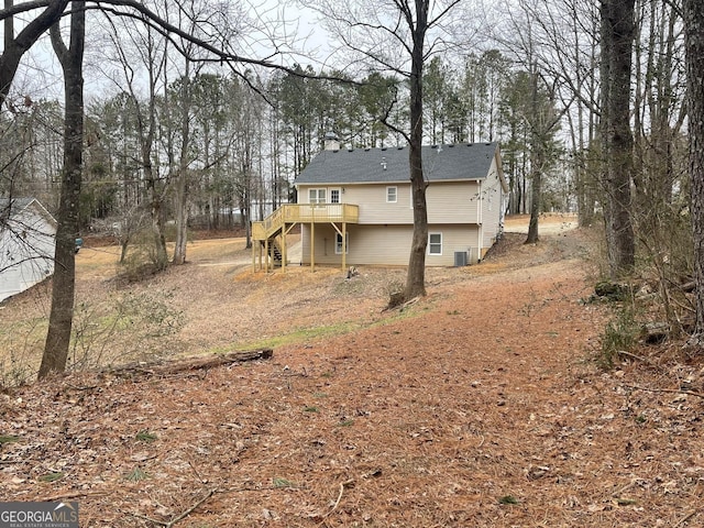 back of house with a wooden deck