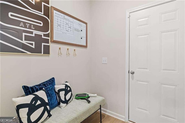 interior space featuring baseboards and wood finished floors