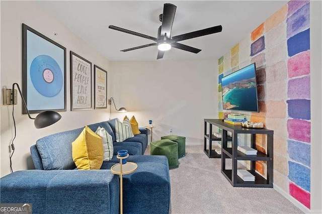 carpeted living room with ceiling fan and baseboards