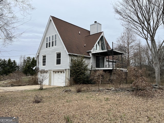 view of property exterior featuring a balcony and a garage