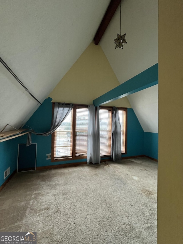 bonus room featuring carpet flooring and vaulted ceiling with beams