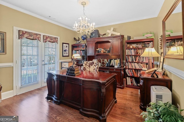 office space featuring a notable chandelier, dark wood-type flooring, and ornamental molding