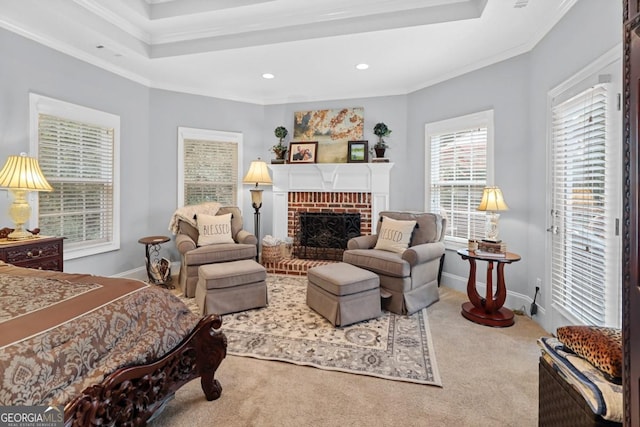 bedroom with ornamental molding, a raised ceiling, carpet, and a brick fireplace