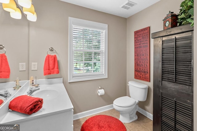 bathroom featuring vanity, tile patterned floors, a chandelier, and toilet