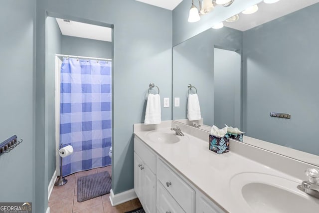 bathroom with tile patterned floors, toilet, and vanity