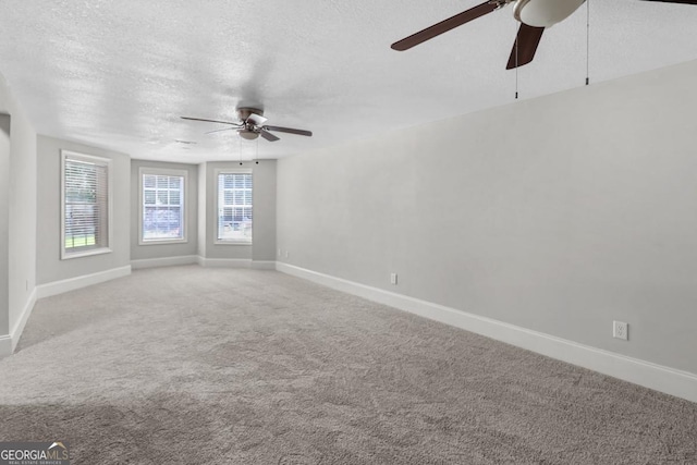 carpeted spare room with a textured ceiling