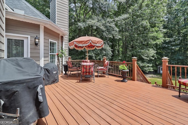 wooden terrace featuring a grill