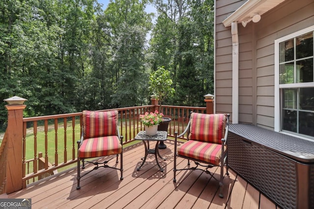 wooden terrace featuring a yard