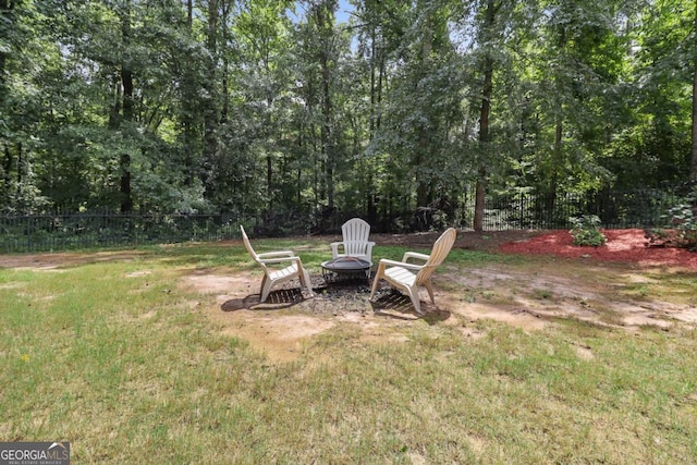 view of yard with a fire pit