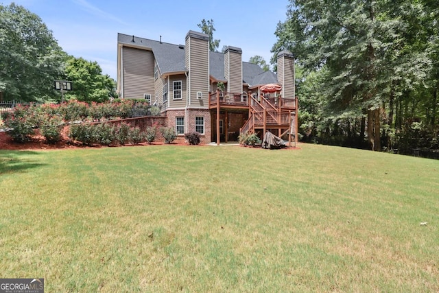 back of house with a wooden deck and a lawn