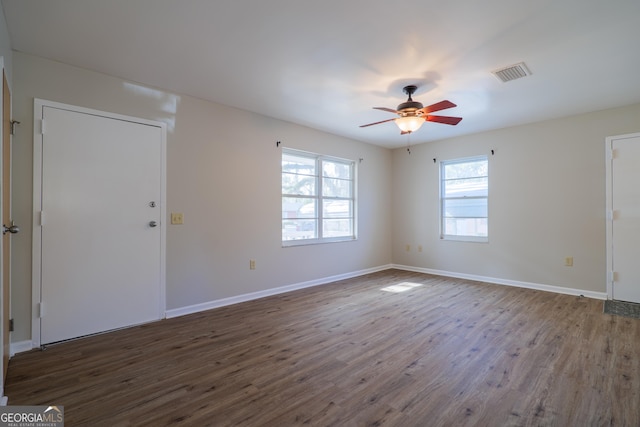 spare room featuring ceiling fan and dark hardwood / wood-style flooring