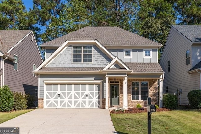 craftsman house featuring a garage and a front lawn