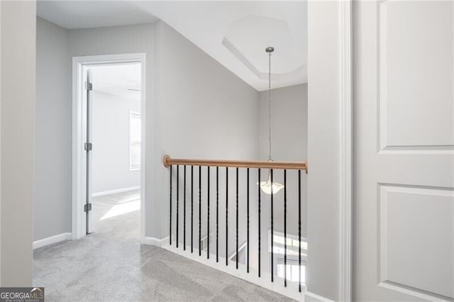 corridor featuring light carpet and vaulted ceiling