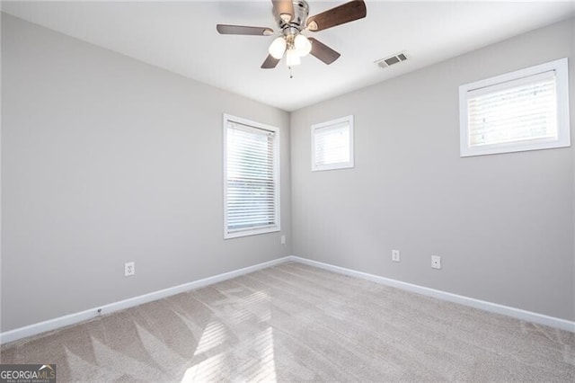 spare room with light carpet and ceiling fan