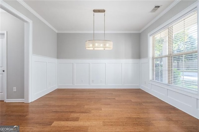 unfurnished dining area with crown molding and light hardwood / wood-style flooring