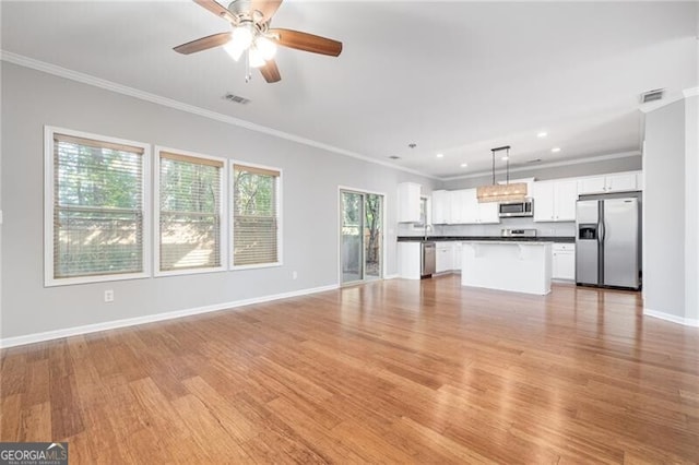 unfurnished living room with light hardwood / wood-style flooring and ornamental molding