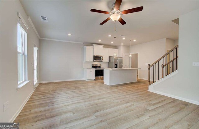 spare room featuring ceiling fan and light wood-type flooring