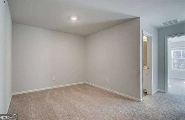 hall featuring washer / dryer and light colored carpet