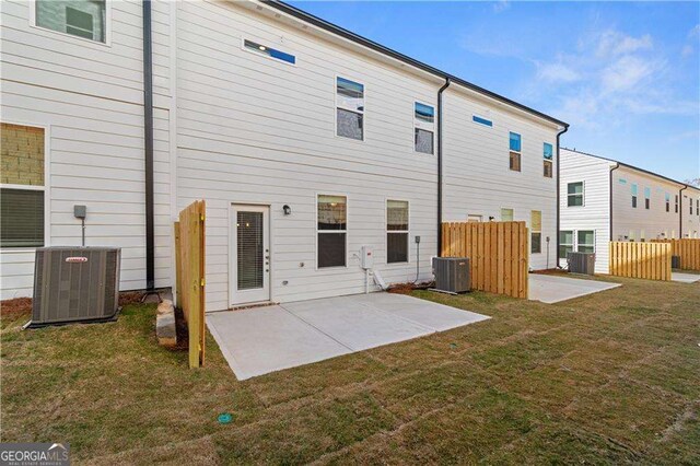 rear view of property with central AC, a yard, and a patio