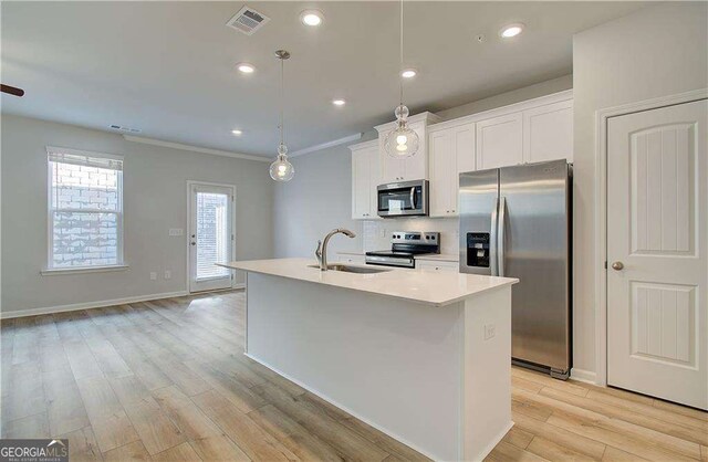 foyer with sink, light hardwood / wood-style flooring, and crown molding