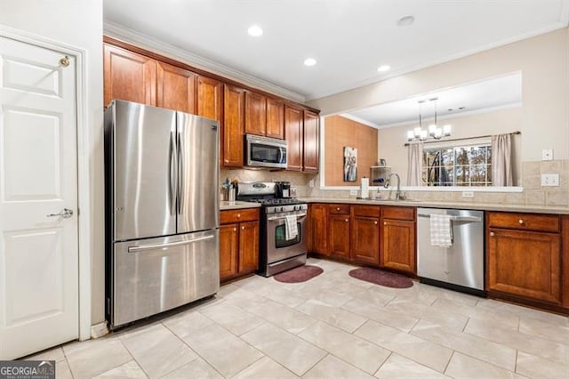 kitchen with light countertops, appliances with stainless steel finishes, and brown cabinetry