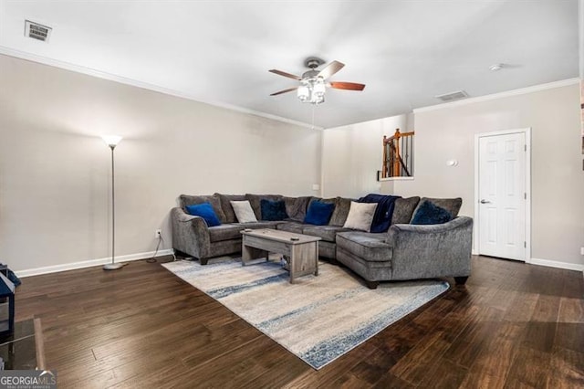 living room featuring visible vents, baseboards, and wood finished floors