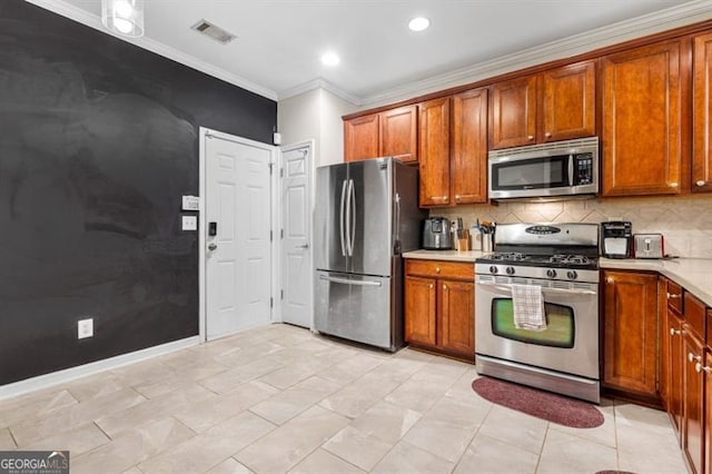 kitchen featuring brown cabinets, visible vents, appliances with stainless steel finishes, and light countertops